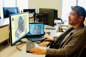 Man looking at digital twin on computer